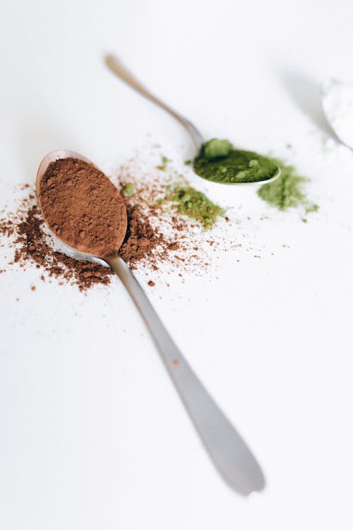 Free Brown Powder on Stainless Spoon on White Surface Stock Photo