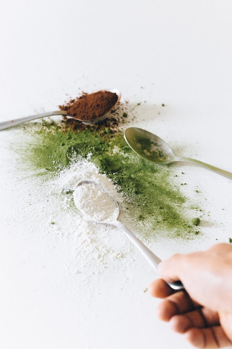 Person Holding Silver Spoon With White Powder