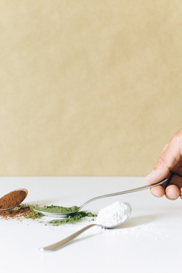 Person Holding Silver Spoon With Powder