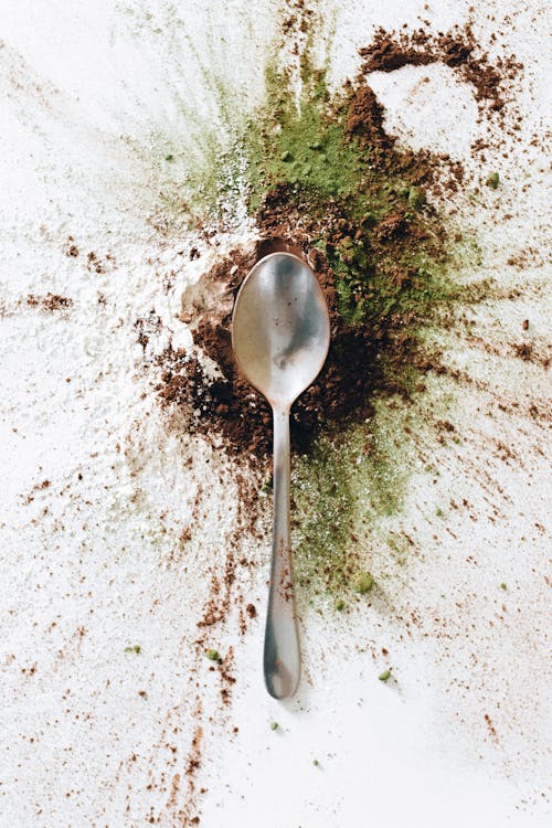 Silver Spoon on Brown and Green Powder