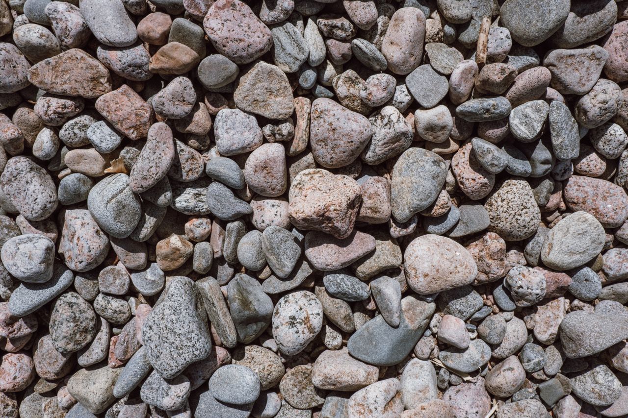 a detailed close up of colorful pebbles perfect for nature themed back