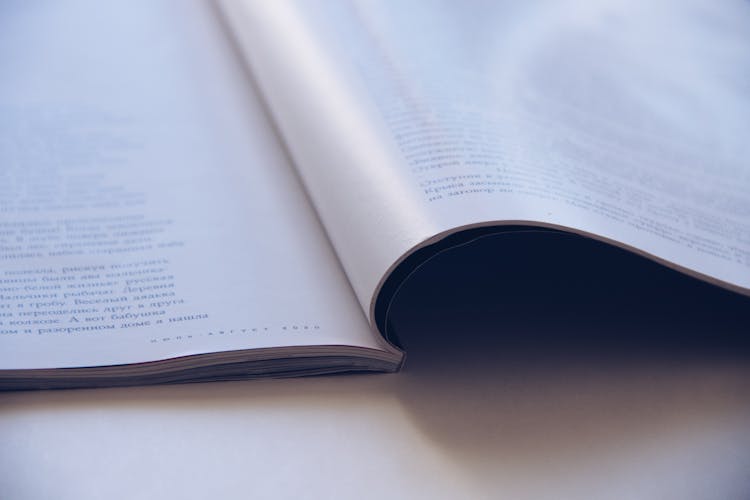 Opened Book On White Table