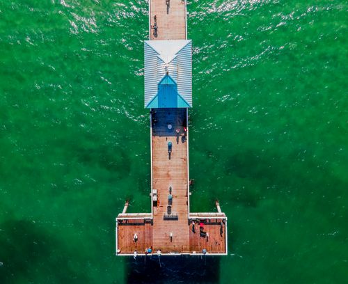 Free Stunning aerial view of Deerfield Beach Pier, showcasing vibrant green waters and a sunny day. Stock Photo