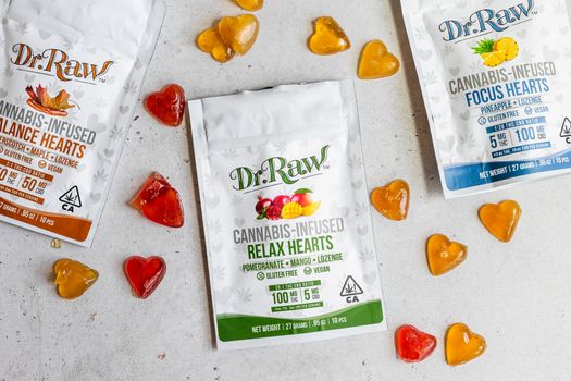 Colorful cannabis-infused gummies and packages arranged on a white background.