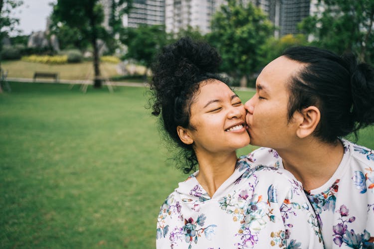 Man Kissing A Woman On The Cheek