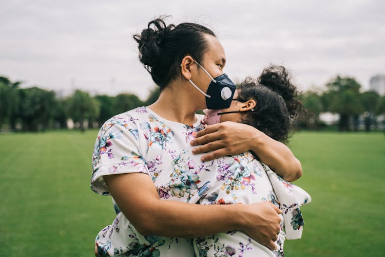 Couple With Face Masks Hugging