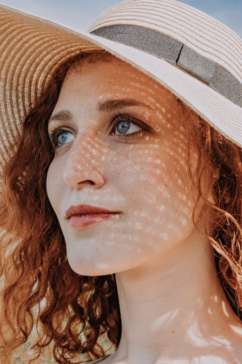 Portrait of a Pretty Redheaded Woman Wearing a Sun Hat