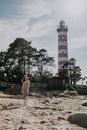 Woman in Dess Walking ear a Tower