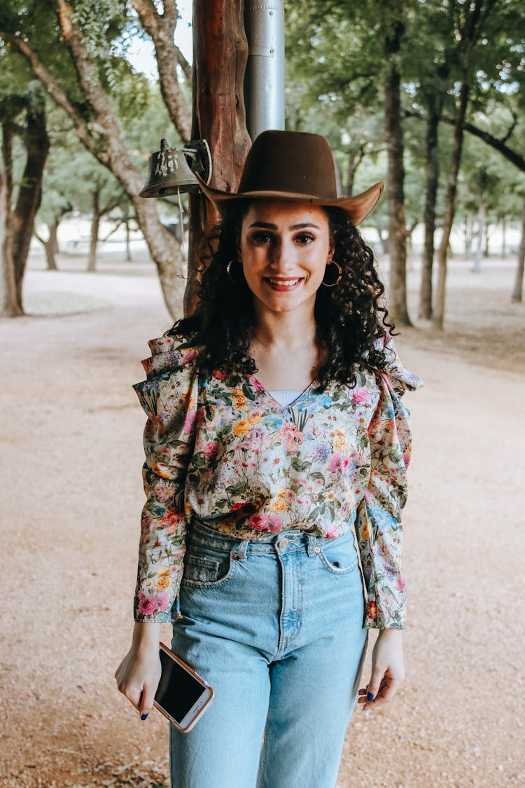 Cheerful Trendy Woman In Jeans And Cowboy Hat
