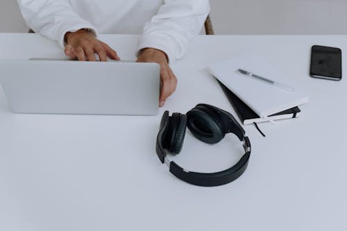 Person in White Dress Shirt Using Macbook