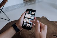 一个人在室内用智能手机在流媒体平台上探索和选择节目