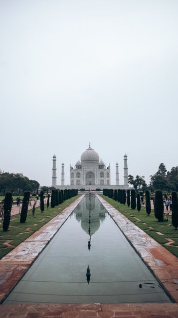 Stunning view of the Taj Mahal with perfect reflection in the water under a clear sky.