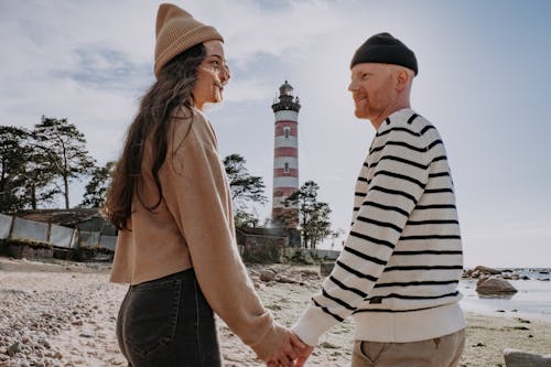 Couple Looking at Each Other While Holding Hands