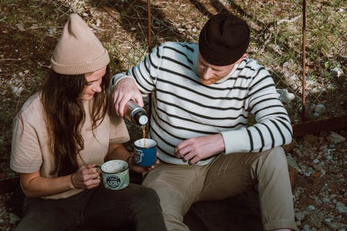 Man Pouring Hot Drink in a Cup