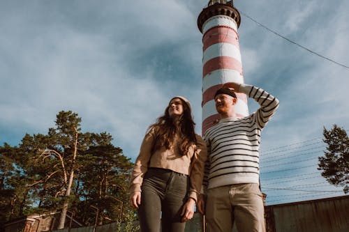 Free People Standing Near a Lighthouse Stock Photo