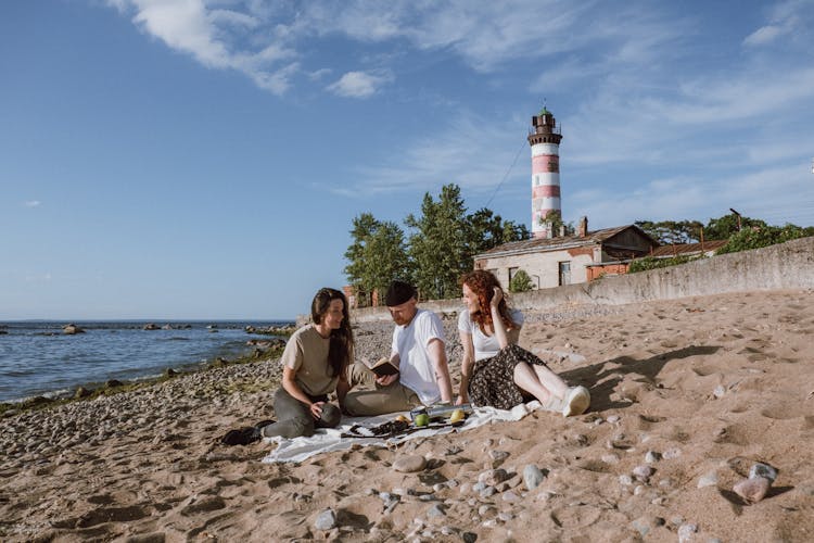 Women And A Man Hanging Out At The Beach