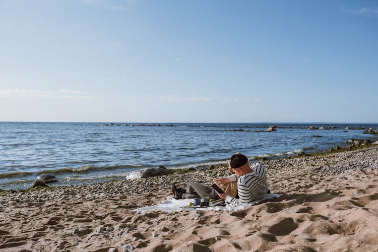 People Relaxing At The Beach