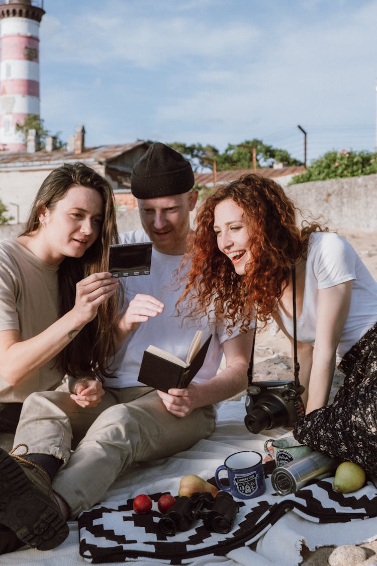 People Looking At A Polaroid