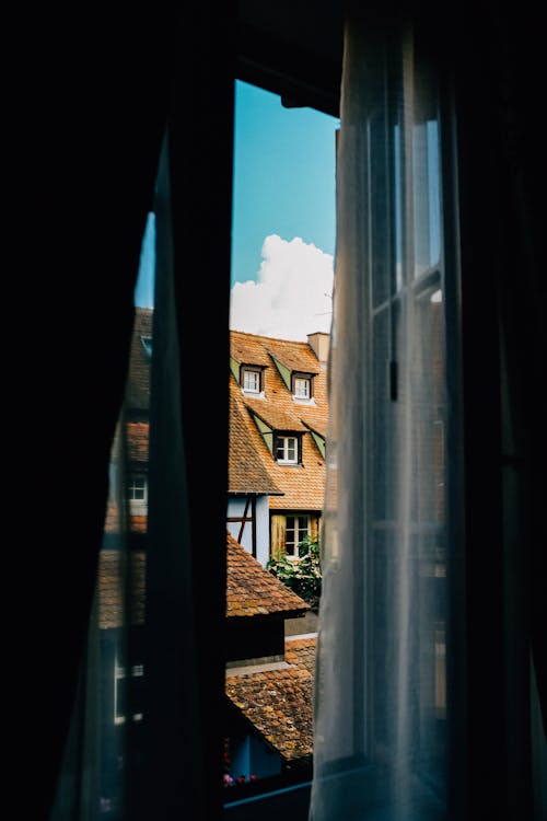 Free View of aged buildings through open window Stock Photo