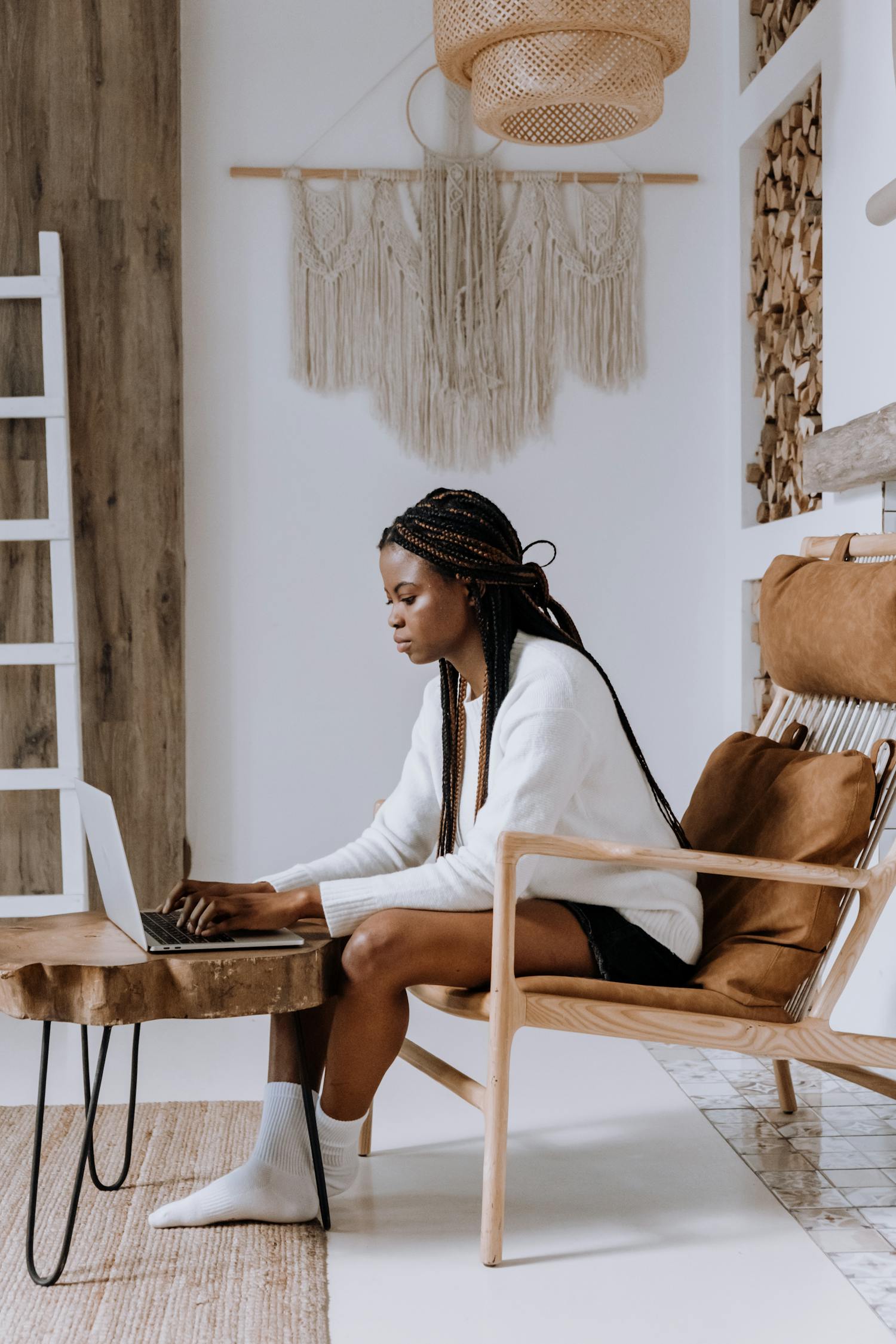 Woman in White Long Sleeve Shirt Sitting on Brown Wooden Chair