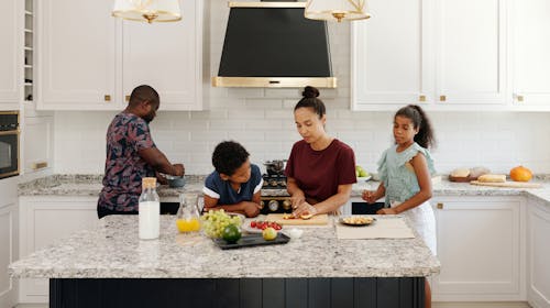 Free A Family Preparing Food Together in the Kitchen Stock Photo