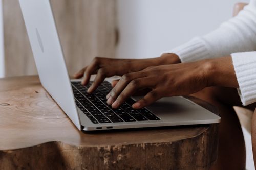 Free Hands typing on a laptop in a cozy indoor setting, focusing on technology and digital work. Stock Photo