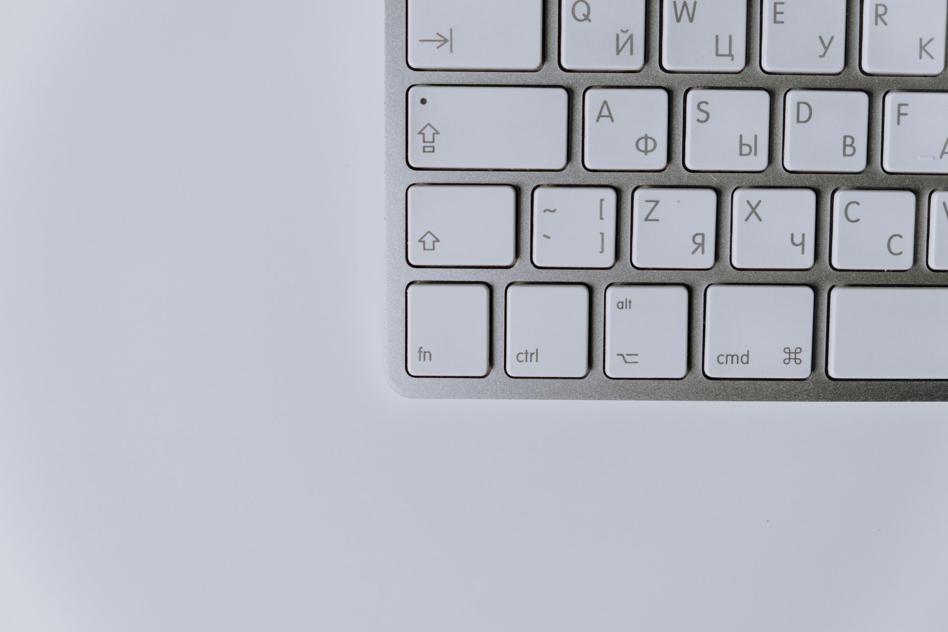 Close-up of a modern keyboard featuring Cyrillic and Latin characters, ideal for technology themes.