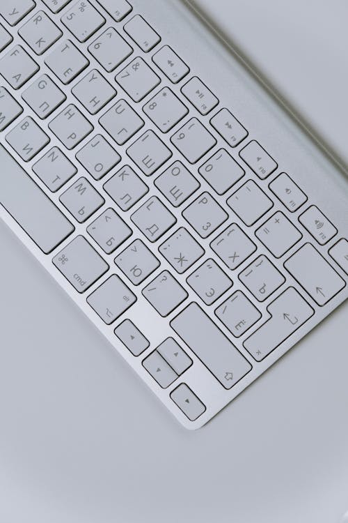 White Apple Keyboard on White Table