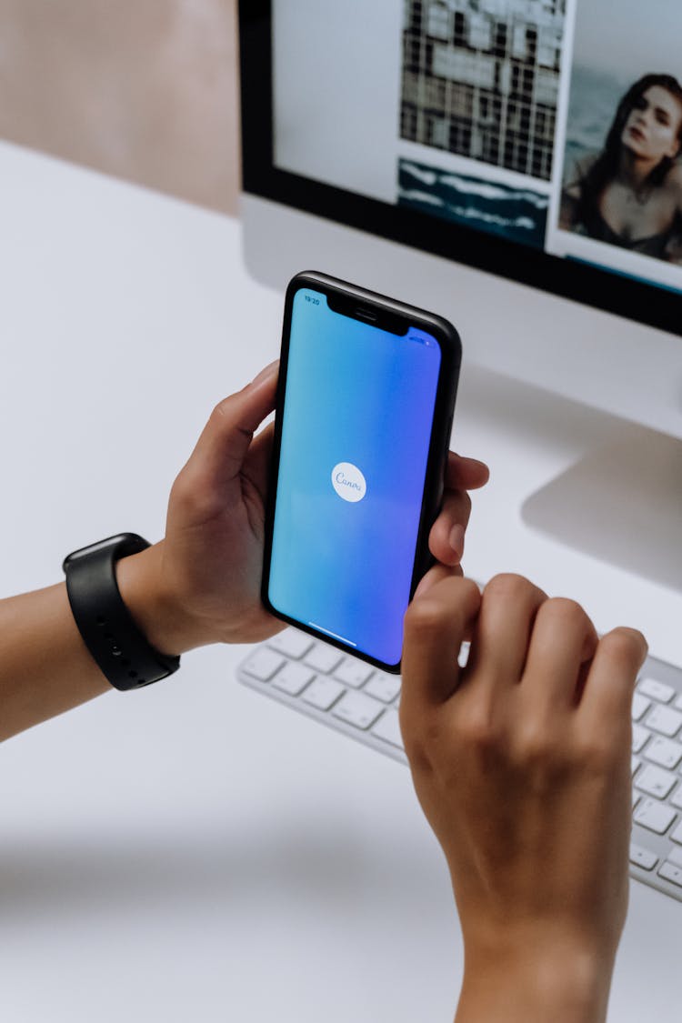 Holding A Smartphone In Front Of An Imac