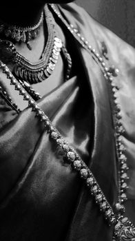 Close-up of ornate Indian bridal jewelry in monochrome showcasing intricate details and cultural craftsmanship.