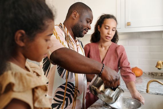 Family preparing a meal together in a bright modern kitchen