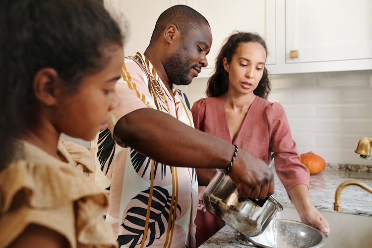 A Family Cooking In The Kitchen