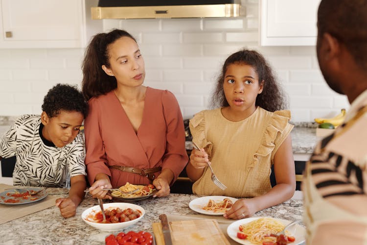 Family Eating Breakfast In A Kitchen