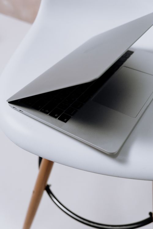 Macbook Pro on White Table · Free Stock Photo