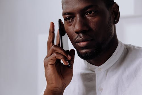 Man in White Dress Shirt Holding Smartphone