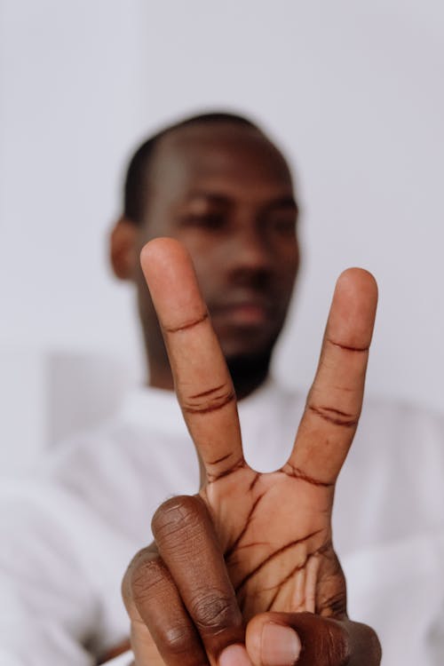 Man in White Dress Shirt Showing His Middle Finger