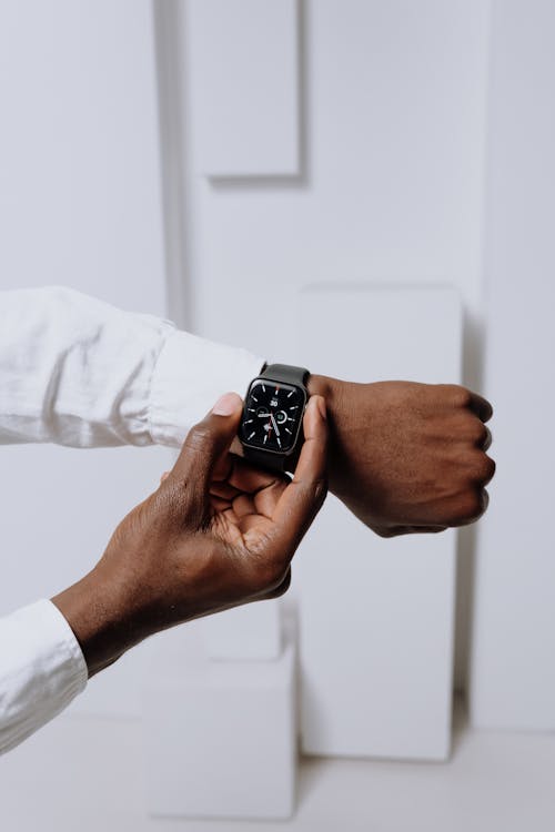 Free Person Wearing Silver Aluminum Case Apple Watch With White Sport Band Stock Photo