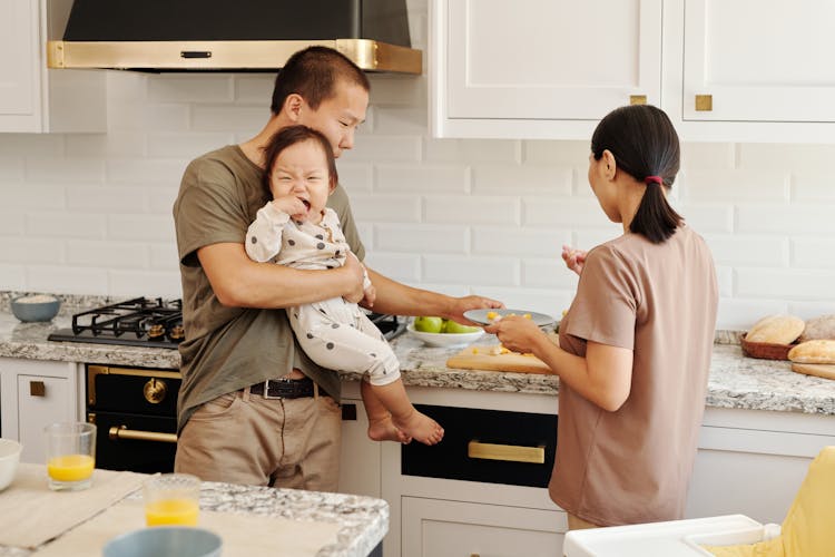 Parents Preparing Food For Their Child