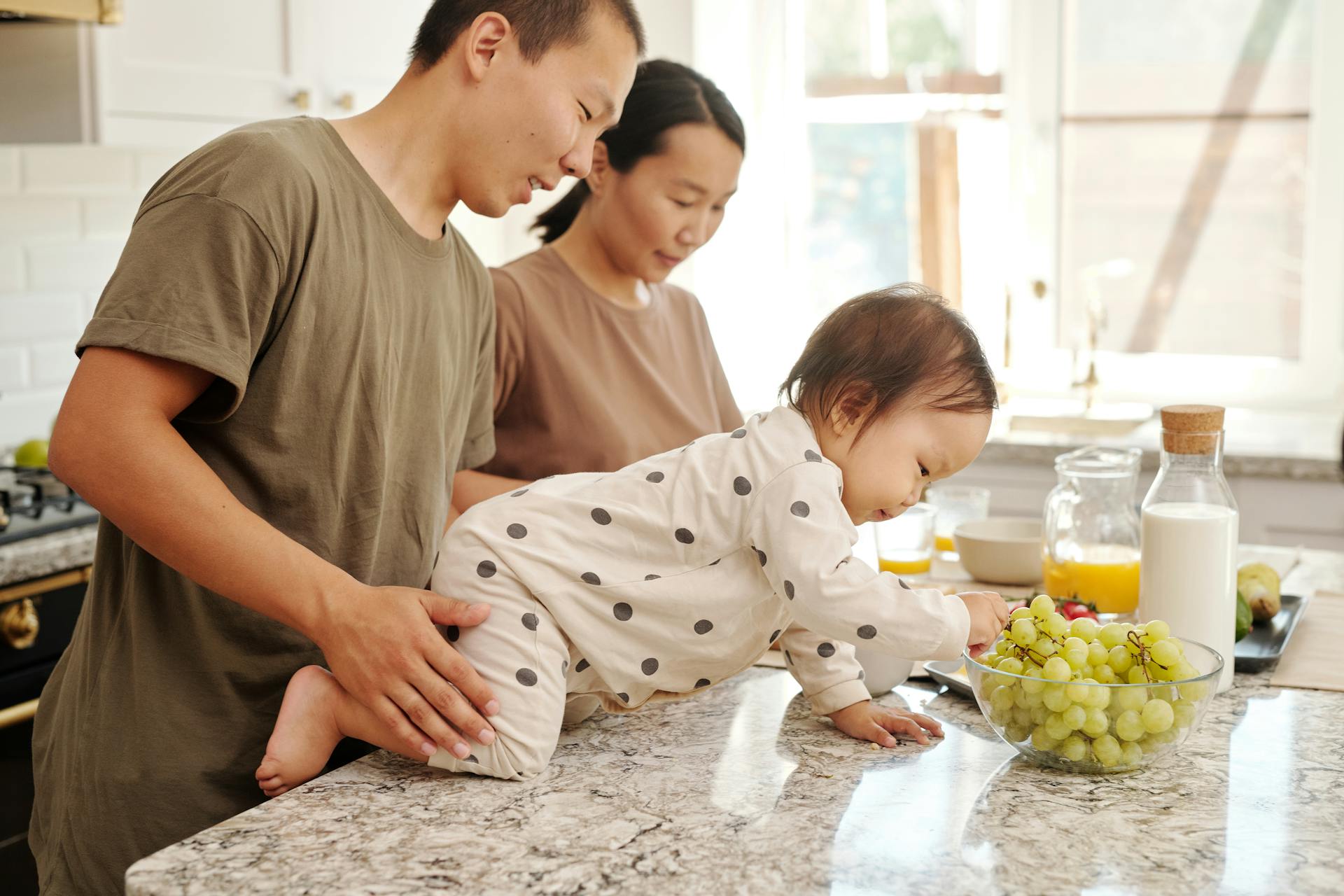 A Toddler Picking Fresh Grape in a Bowl