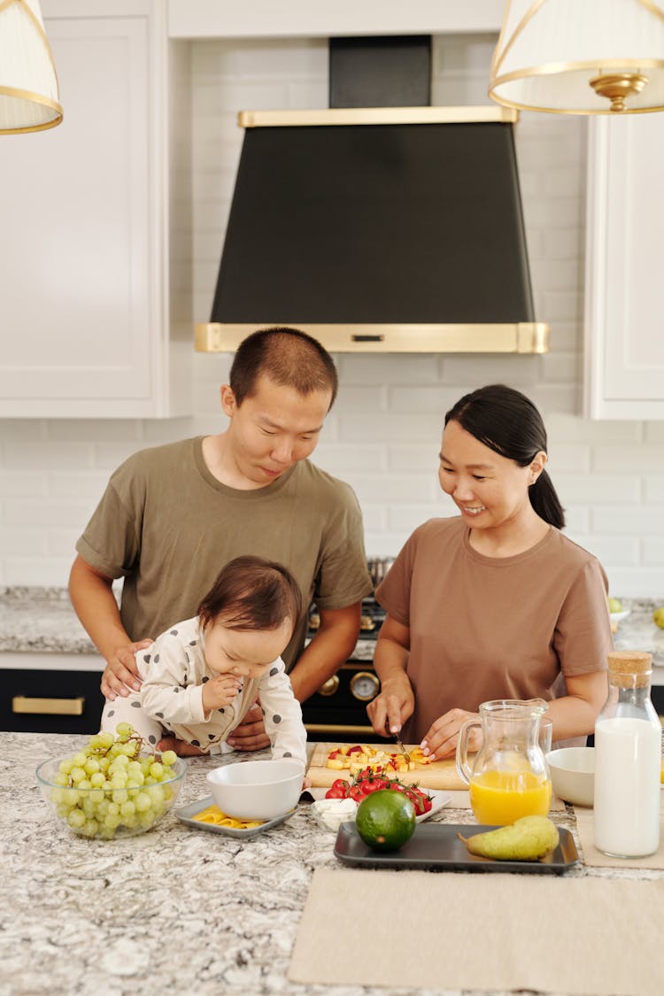 Parents Watching Their Child Over The Table