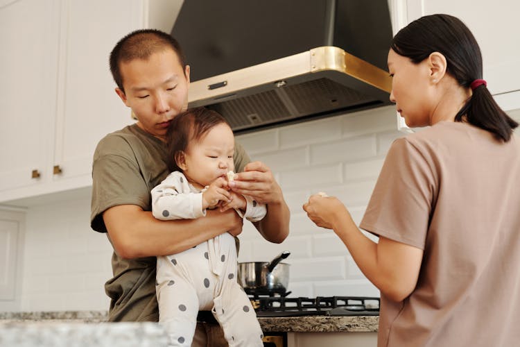 Parents Feeding Their Baby