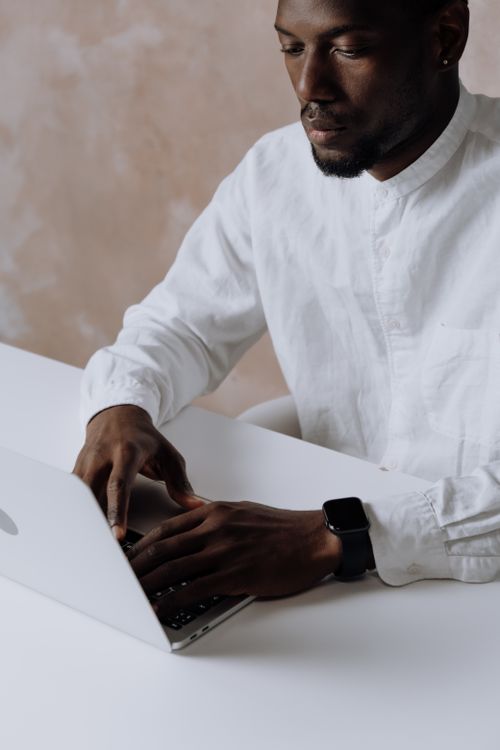 Free Business professional working on a laptop in an office setting, focused and attentive. Stock Photo