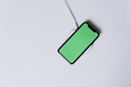 Green Iphone 5 C on White Surface