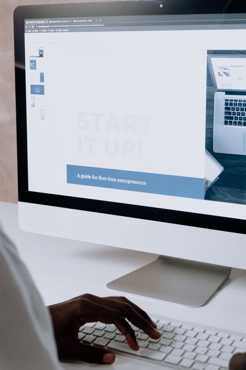 Person working on a website design on desktop computer
