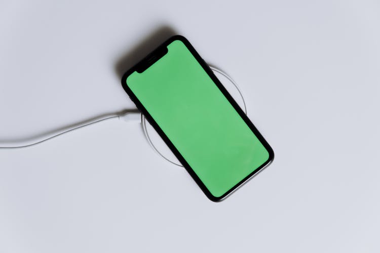 Green Iphone Case On White Surface