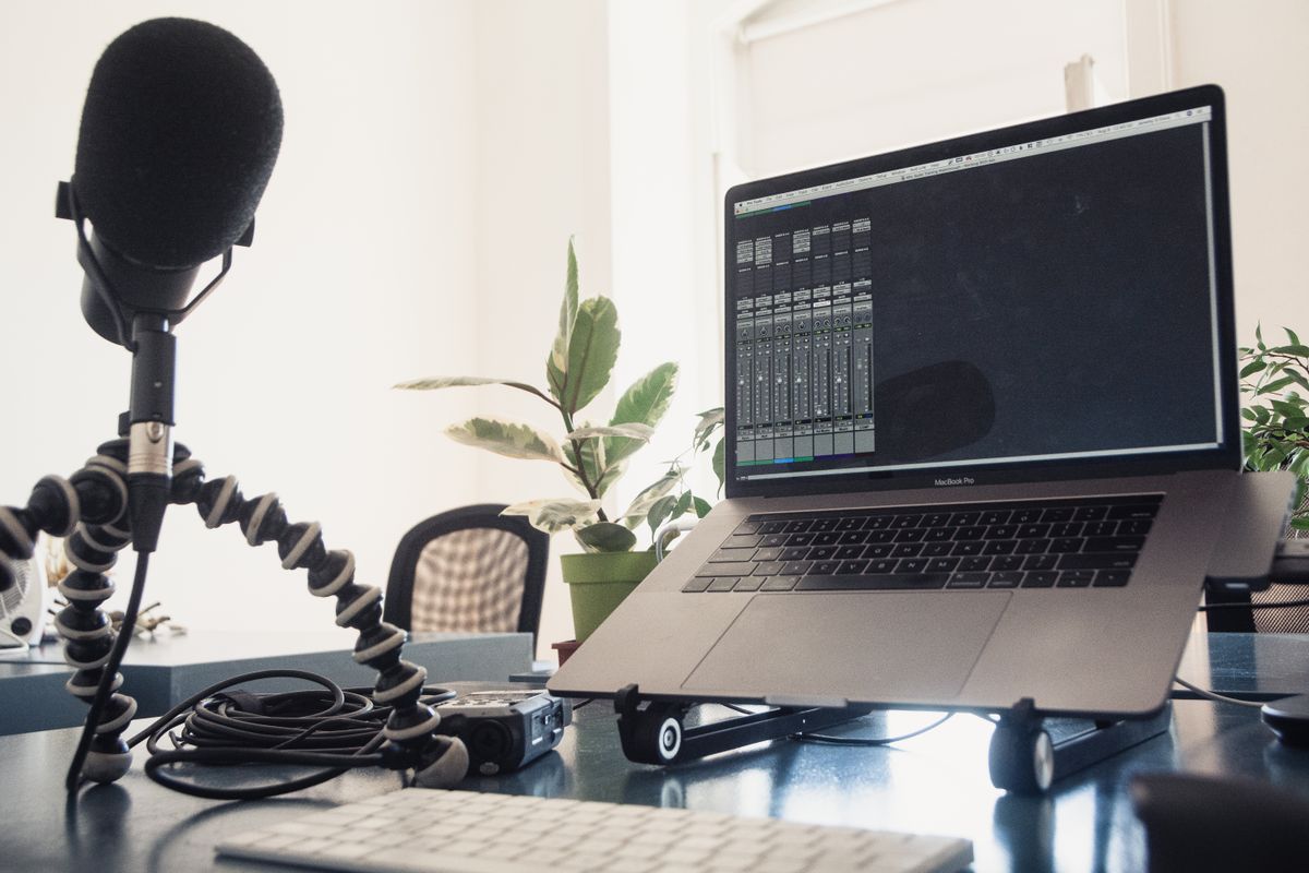 Studio setup with laptop and microphone for content production