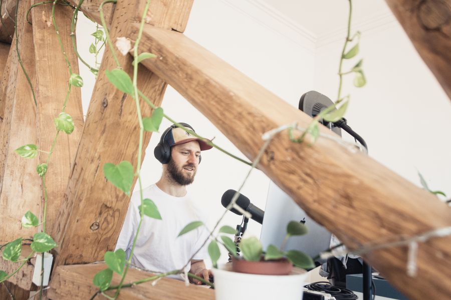 Podcaster recording in a bright studio — photo by Jeremy Enns on Pexels