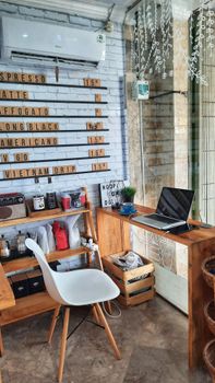 Charming café interior in Denpasar, Bali, showcasing rustic design and coffee culture.