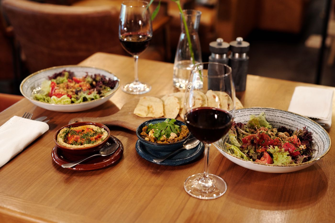 A table of shared plates and wine at Saltmarsh — photo by Jep Gambardella on Pexels