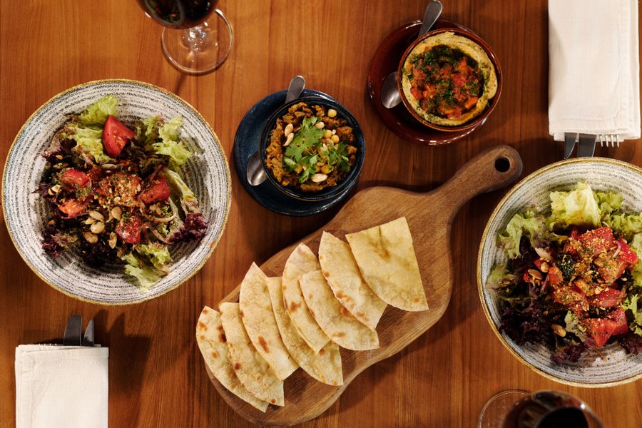 Overhead view of shared dishes on a table, photo by Jep Gambardella on Pexels